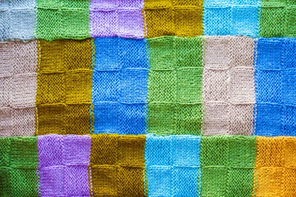 Texture of multicolored fragments of knitted cover,background of colorful threads — Stock Photo, Image