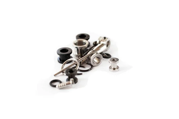 Conjunto de acessórios piercing preto e branco velho no fundo branco. Isolar — Fotografia de Stock