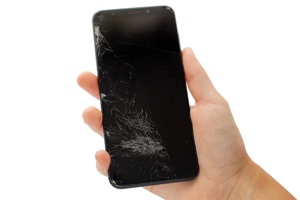 Teléfono roto negro en la mano sobre fondo blanco agrietado pantalla táctil aislar — Foto de Stock