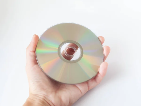 Cd compact disc con film e musica, dvd disc in mano su sfondo bianco — Foto Stock