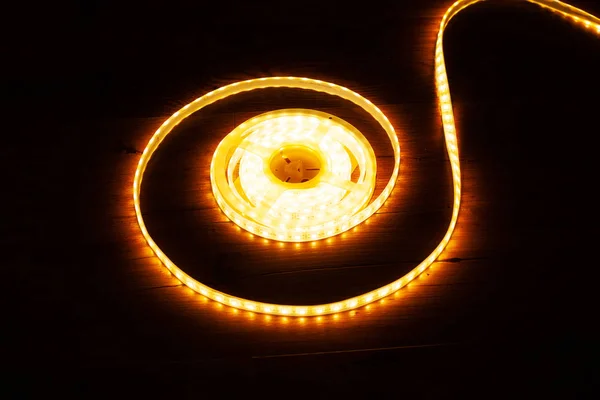 Yellow-orange led strip for home decorative light on a dark background — Stock Photo, Image
