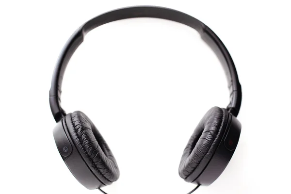 Black headphones on a white background, left and right headphones with a frame rim for listening to loud music Stock Photo