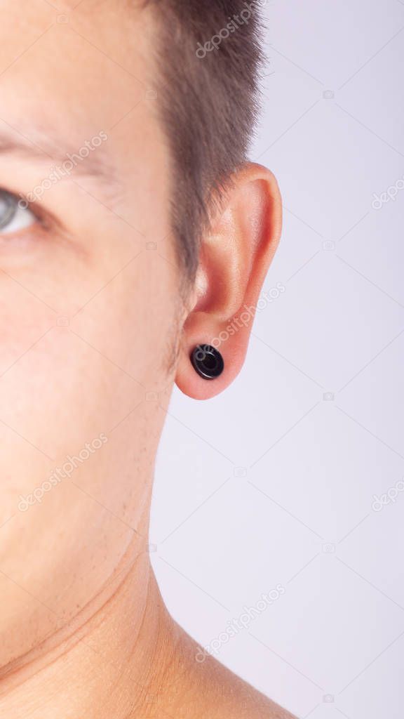 ear pierced guy,man wears a piercing