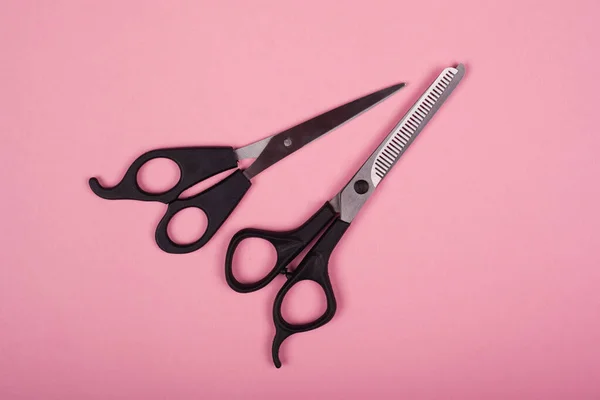 Scissors for haircuts on a pink background — Stock Photo, Image