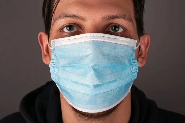Porträt eines kaukasischen Mannes mit medizinischer Maske aus nächster Nähe — Stockfoto