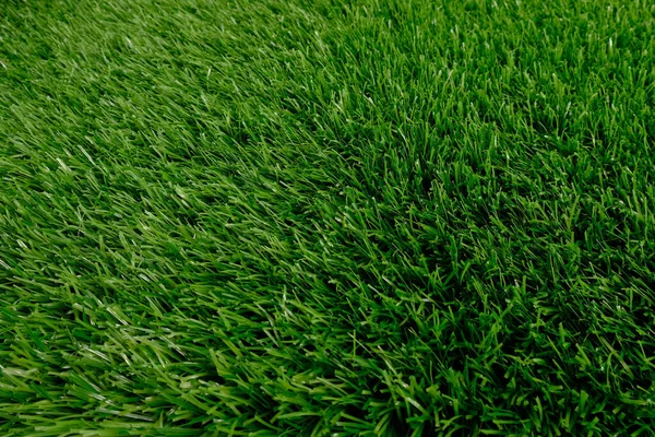 Zielony sztuczna trawa widok z góry. pokrycia podłogowe. tło, przestrzeń kopiowania — Zdjęcie stockowe