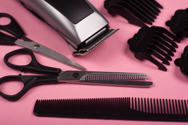 haircut accessories, barber tools on a pink background