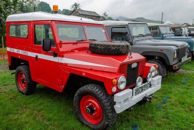 Bala Lake, UK: May 27, 2018: Despite the poor weather, The Festival of Transport saw a good turn out of classic cars, tractors, bikes, Landrovers, commercial vehicles, side stalls & traders.  clipart