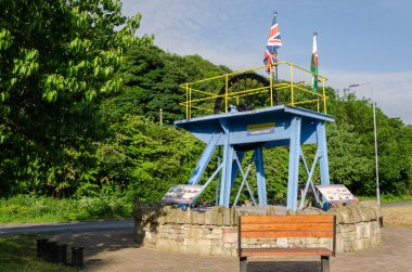 Ffynnongroyw, UK: June 3, 2018: A headgear from the nearby Point of Ayr colliery is a lasting memorial. The pit was the last deep pit in North Wales when it closed in 1996.  clipart