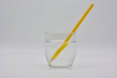 Refraccion de la luz, demostrada en un vaso de agua con lapices de colores