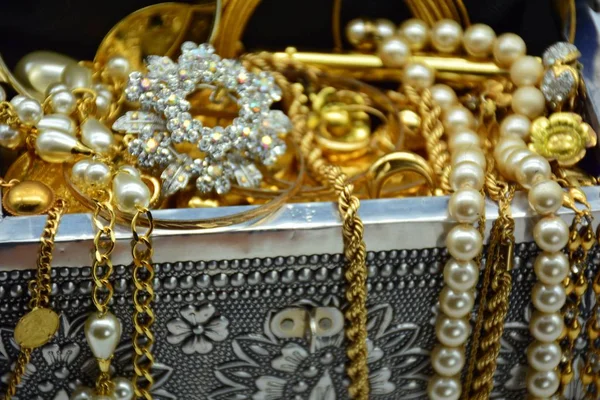 The treasure chest full of jewels, jewelry, pearls and gold