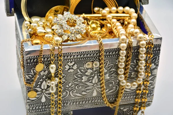 The treasure chest full of jewels, jewelry, pearls and gold