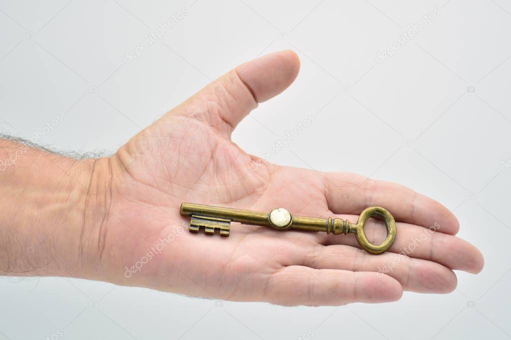 hand holding an old key in different ways