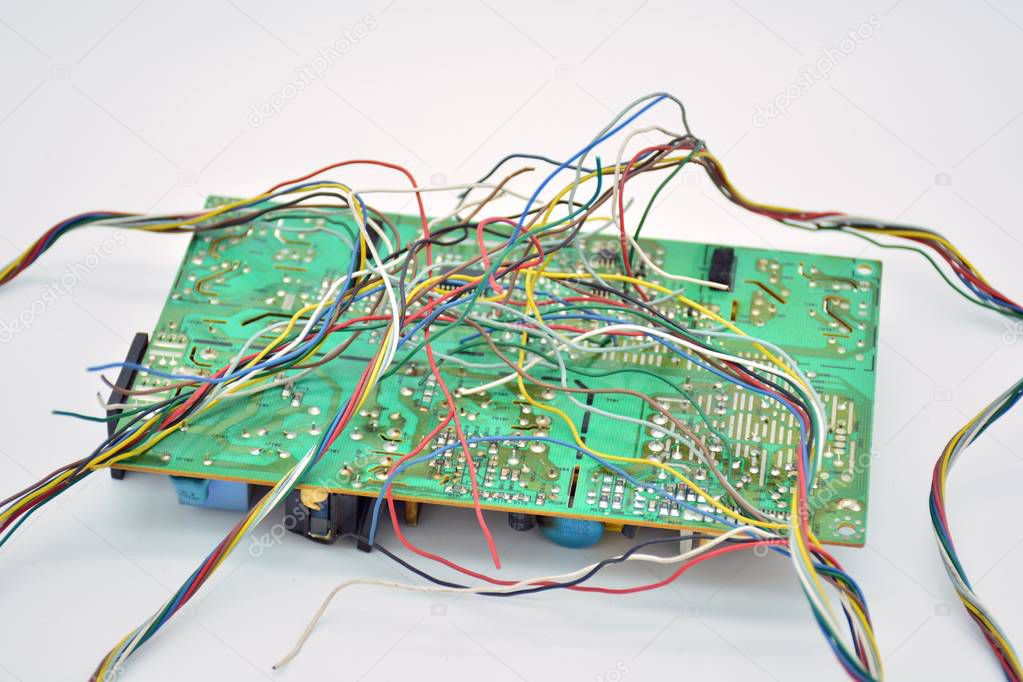Broken electronic circuit with a tangle of loose electrical wires