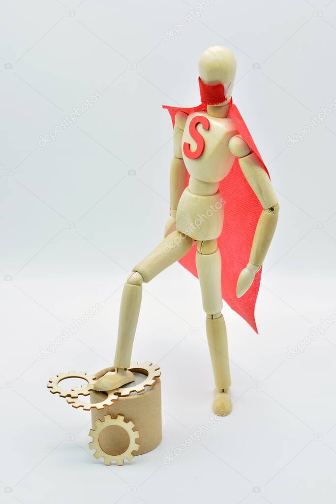 wooden figure with cape and mask stepping on a virus