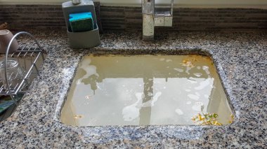 Overflowing kitchen sink, clogged drain. Plumbing problems. clipart