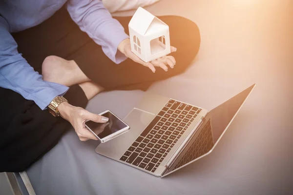 Yeni ev concept için planya kredi. Evde yatakta eve model ve dizüstü bilgisayar ile telefon tutarak işkadını.