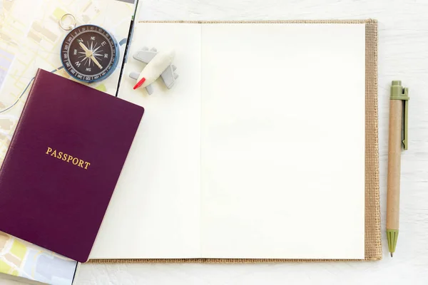 Travel background concept. Passport with plane and compass put on empty white paper for text. Picture for add text message. Backdrop for design art work.