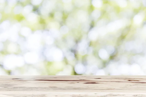 Blank wooden table top for show product with blurred natural background. Picture for add text message. Backdrop for design art work.