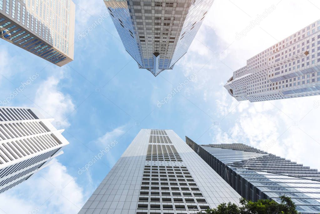 Exterior of modern high building in business city center with blue sky. Picture for add text message. Backdrop for design art work.