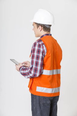 Beyaz arka plan üzerinde cep telefonu tutan mühendislik adam portresi.