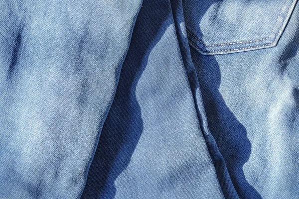 Sfondo astratto da blue jeans con luce solare . — Foto Stock