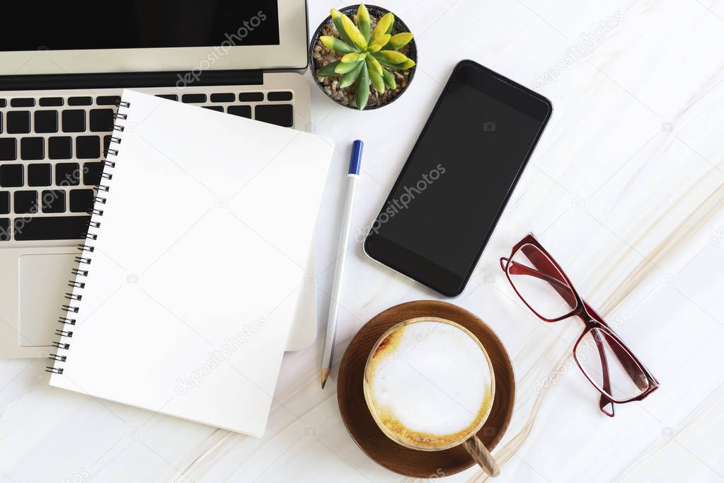 Blank white paper note book with pencil, glasses, coffee cup, mo