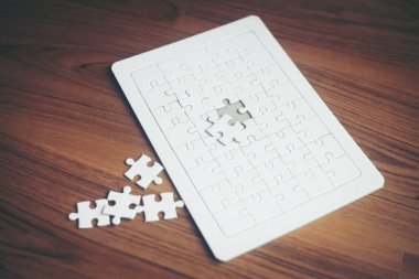 Jigsaw puzzles on wood background, Business partnership concept.