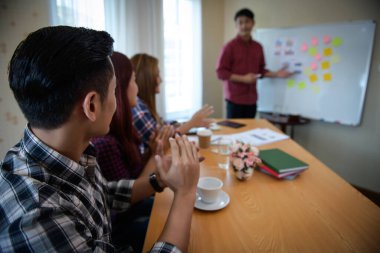Happy group of business people clapping in office meeting hands applauding at conference success and perfect presentation.