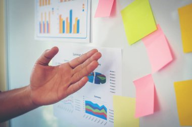 Close-up hand present business graph chart on whiteboard. planning concept.