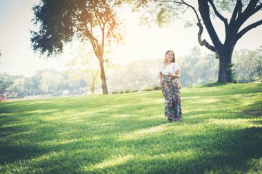 Young woman walking in a park, Relax concept