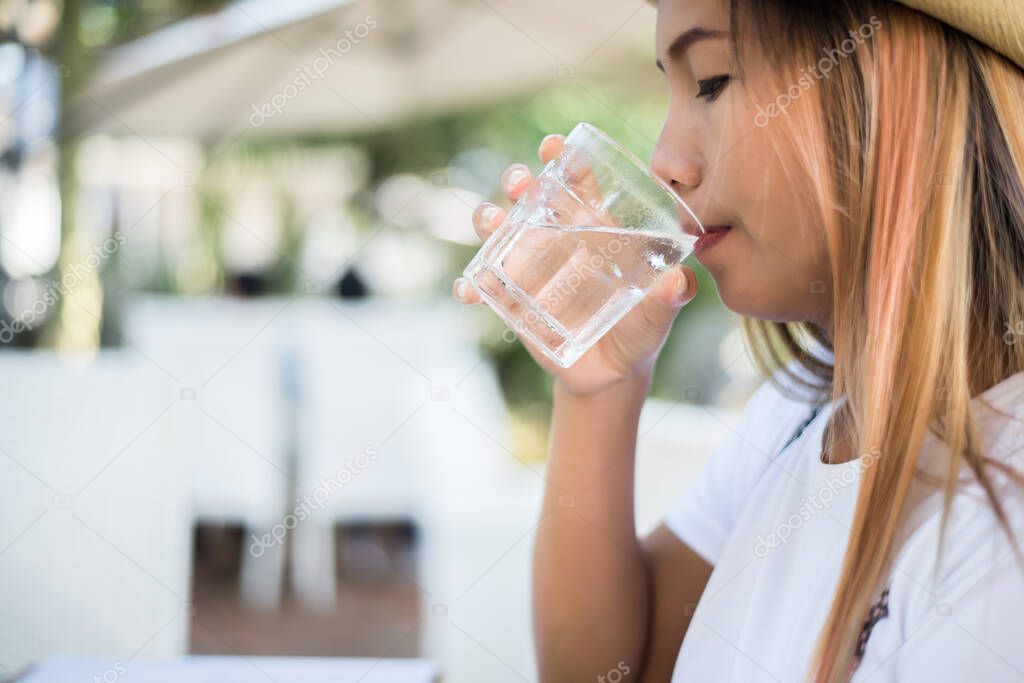 Woman drinking from a glass of water. Drink water for Healthy.