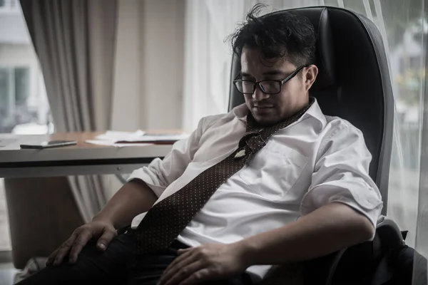 Worried business man at workplace in office after tired from hard work. Fail business concept.