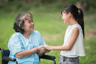 Yaşlı büyükanne ve torunu hastane bahçesinde.