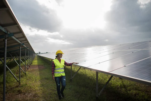 Engineer electric woman checking and maintenance of solar cells.