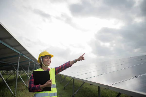 Engineer electric woman checking and maintenance of solar cells.