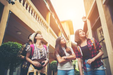 Bir grup mutlu genç arkadaş şehir caddesinde yürürken eğleniyor. Arkadaşlık seyahati kavramı.