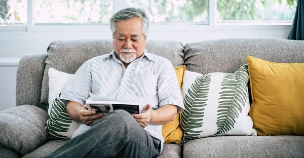 Old man reading at living room