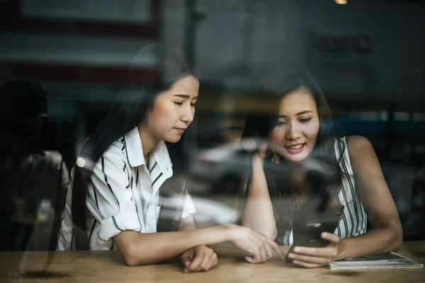 Two beautiful women talking everything together at coffee shop cafe