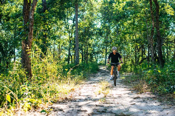 The man riding a bike in a mountain path