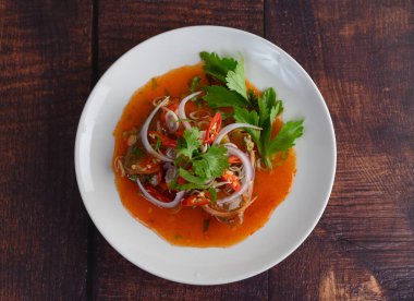 Üst görüntü, ahşap masada domates soslu baharatlı sardalya salatası, bitki ve limonata ile karıştırılmış, kopyalama alanı.