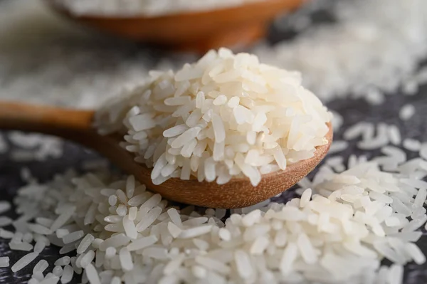 Milled Rice Bowl Wooden Spoon Black Cement Floor Selective Focus — Stock Photo, Image