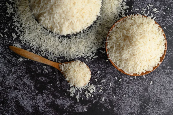 Milled Rice Bowl Wooden Spoon Black Cement Floor Top View — Stock Photo, Image