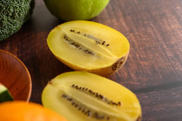 Half Cut Yellow Kiwi Wooden Table Selective Focus — Stock Photo, Image