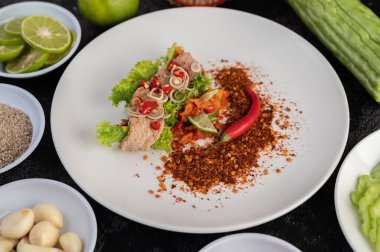 Baharatlı domuz salatası, limon, biber, sarımsak ve beyaz tabakta salata..