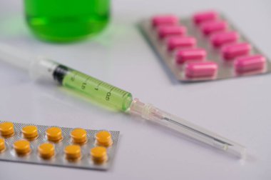 İlaç panelleri, şırıngalar ve şişeler yere konur. Seçici odak.