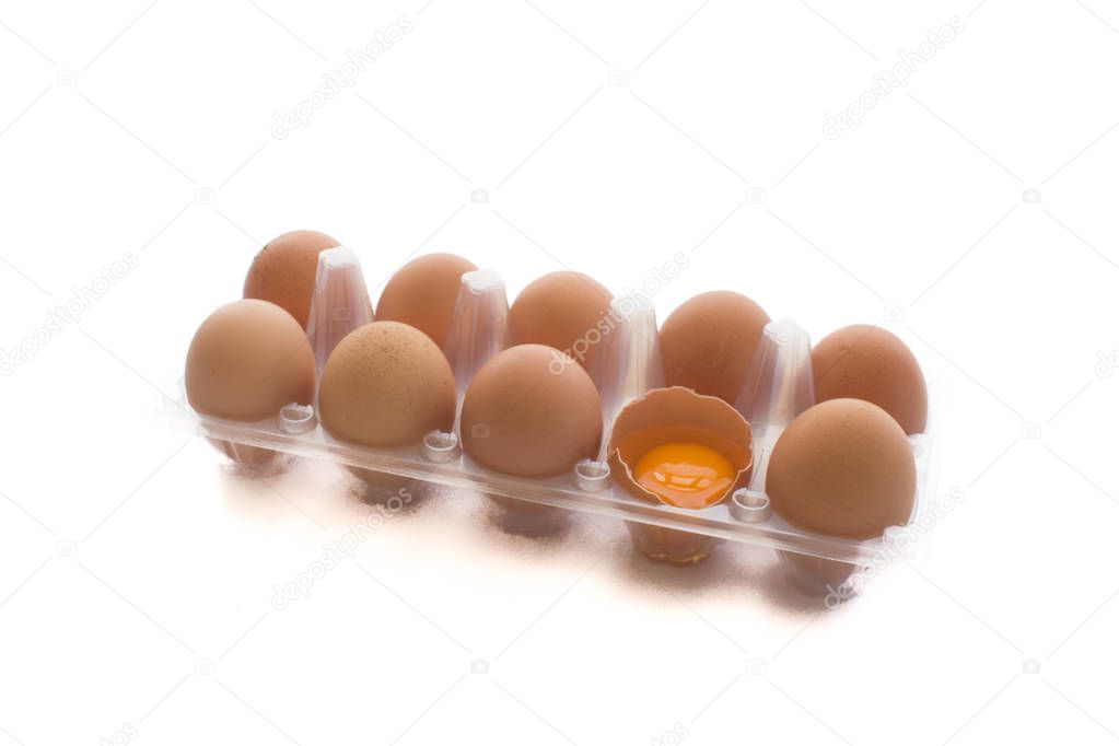 Close-up view of raw chicken eggs in transparent egg box  isolat