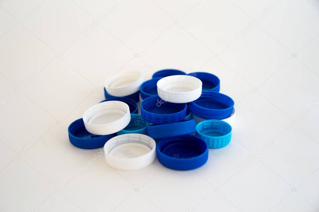 Plastic bottle caps and drinks are on a white background. Isolat