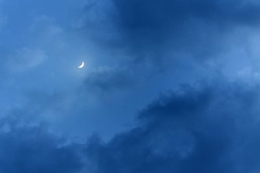 little moon in the big clouds / night cloud landscape the light of the moon clipart