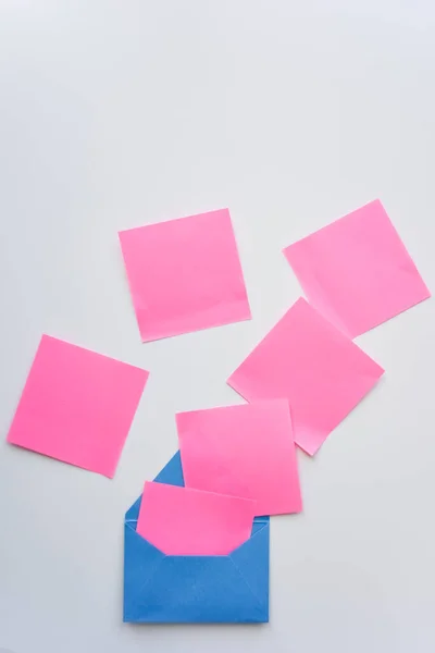 Вибірковий Фокус Рожеві Паперові Наклейки Хаосі Синій Конверт Вниз Білому — стокове фото